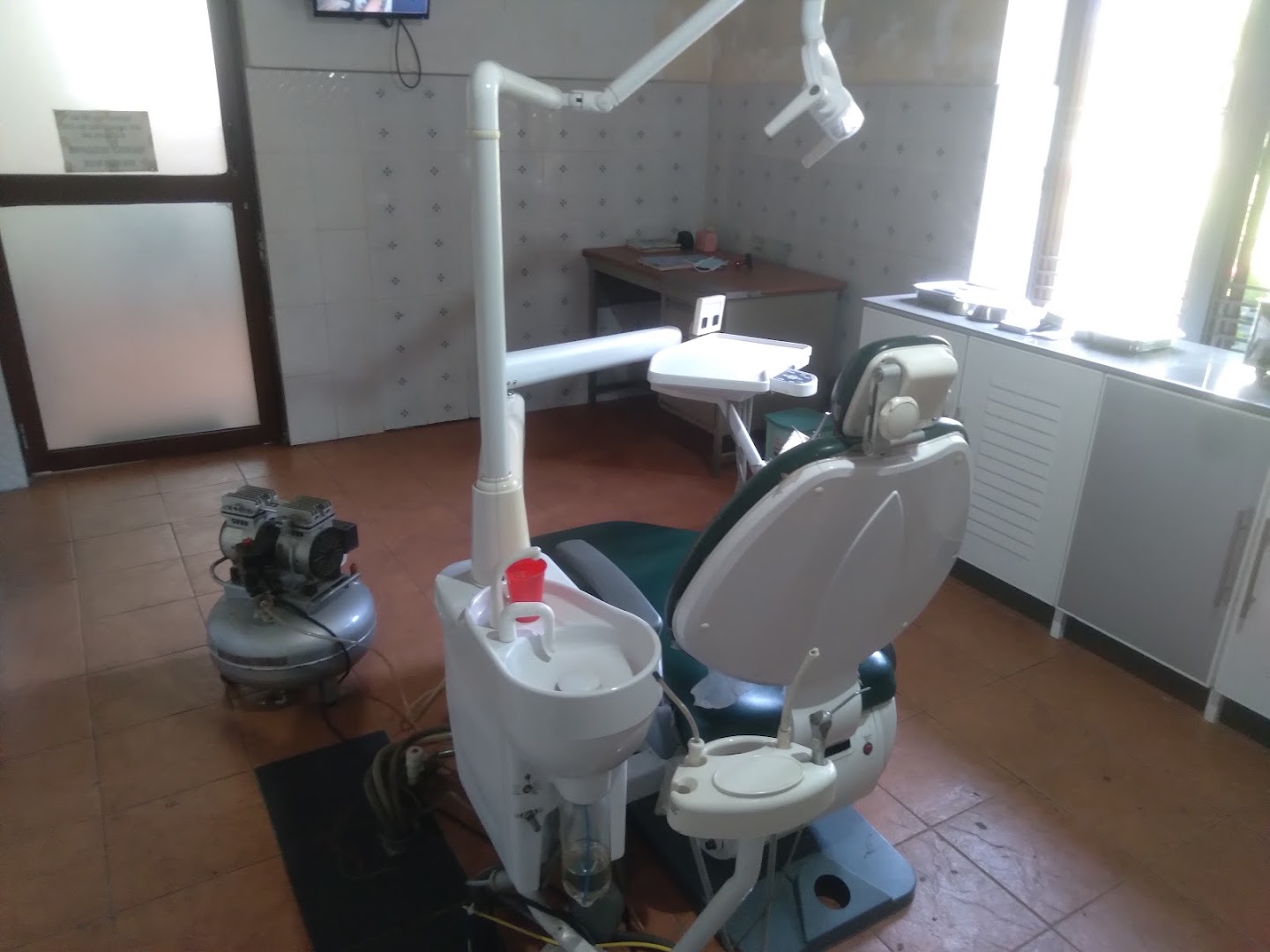 Dental chair and overhead treatment light inside the treatment room